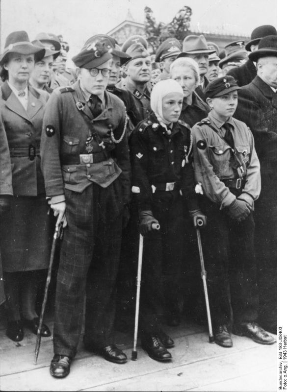 Members of the Hitler Youth at a demonstration, autumn 1943, Photographer: unknown. Source: [https://commons.wikimedia.org/wiki/File:Bundesarchiv_Bild_183-J08403,_Hitlerjungen,_als_Helfer_bei_Luftangriffen_verwundet.jpg#/media/File:Bundesarchiv_Bild_183-J08403,_Hitlerjungen,_als_Helfer_bei_Luftangriffen_verwundet.jpg Bundesarchiv Bild 183-J08403 (ADN) / Wikimedia Commons], license: [https://creativecommons.org/licenses/by-sa/3.0/de/deed.en CC BY-SA 3.0]