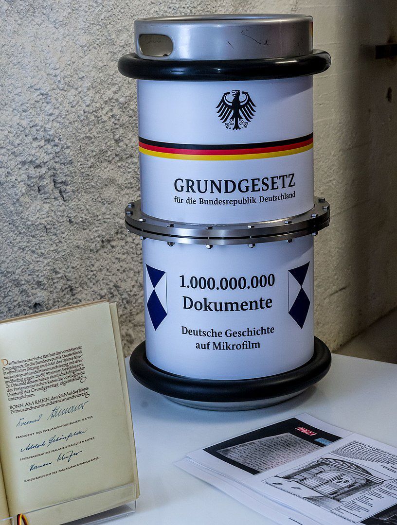 Einlagerung der Dokumente und des Originals des Grundgesetzes für die Bundesrepublik Deutschland als Mikrofilm am 3. Oktober 2016 im Barbarastollen. Der stillgelegte Stollen in der Nähe von Freiburg ist der zentrale Bergungsort der Bundesrepublik Deutschland zur Lagerung von fotografisch archivierten Dokumenten mit hoher national- oder kulturhistorischer Bedeutung. Foto: [https://commons.wikimedia.org/wiki/User:Joergens.mi Joergens.mi/Wikipedia], Quelle: [https://commons.wikimedia.org/wiki/File:Einlagerung_Grundgesetz_im_Barbarastollen_(Oberried)_jm22191.jpg Wikimedia Commons], Lizenz: [https://creativecommons.org/licenses/by-sa/3.0/de/legalcode CC-BY-SA 3.0]