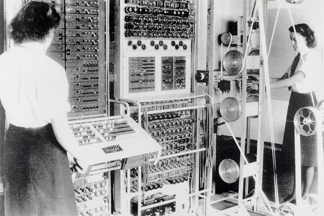 Two members of the British Women’s Royal Naval Service, Dorothy Du Boisson (left) and Elsie Booker (right), on a Colossus Mark 2 at Bletchley Park in 1943. The Colossus was the world’s first vacuum-tube computer, developed to decode the communications of Nazi Germany’s military command. Bletchley Park, headquarters of the British code-breaking service (the Government Code and Cypher School) during World War II, is a British memorial site and a symbol for the victory of the British intellect over the brutality of the German war machine. Less well known is the fact that most of the thousands of individuals working at Bletchley Park were women, whose role has been sorely neglected in intelligence history. Photo: unknown, source: [https://commons.wikimedia.org/wiki/File:Colossus.jpg Wikimedia Commons] / The National Archives (United Kingdom) FO850/234, public domain